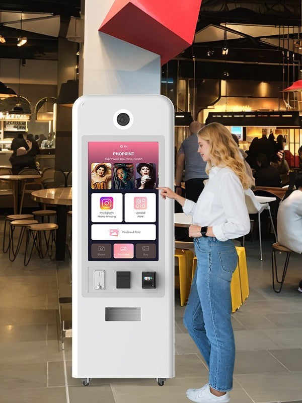 Person interacting with a digital Foto kiosk in a modern indoor setting