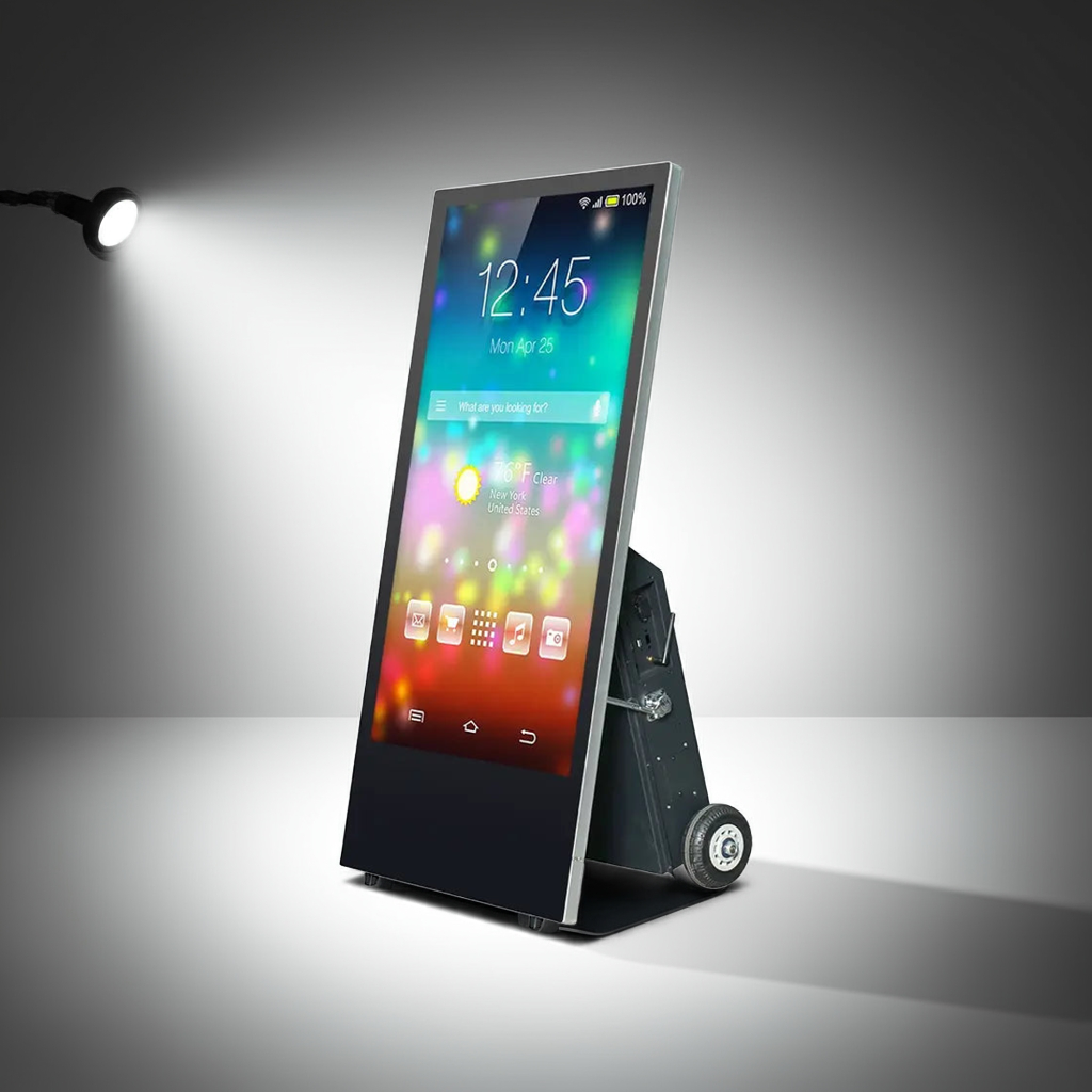 A portable promotional poster display with a 43 inch screen showcasing a colorful digital image. The unit is on a wheeled base, suggesting mobility for indoor or outdoor use.