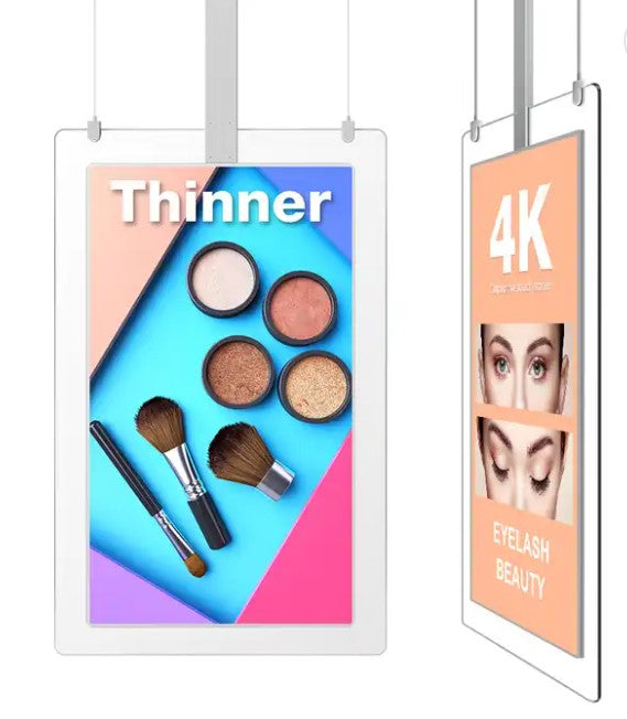 Two transparent LED displays, one showcasing a makeup kit with brushes and shades, and the other displaying a close-up of eyes with eyelashes. Both are hanging indoors and have a reflective white ceiling above.